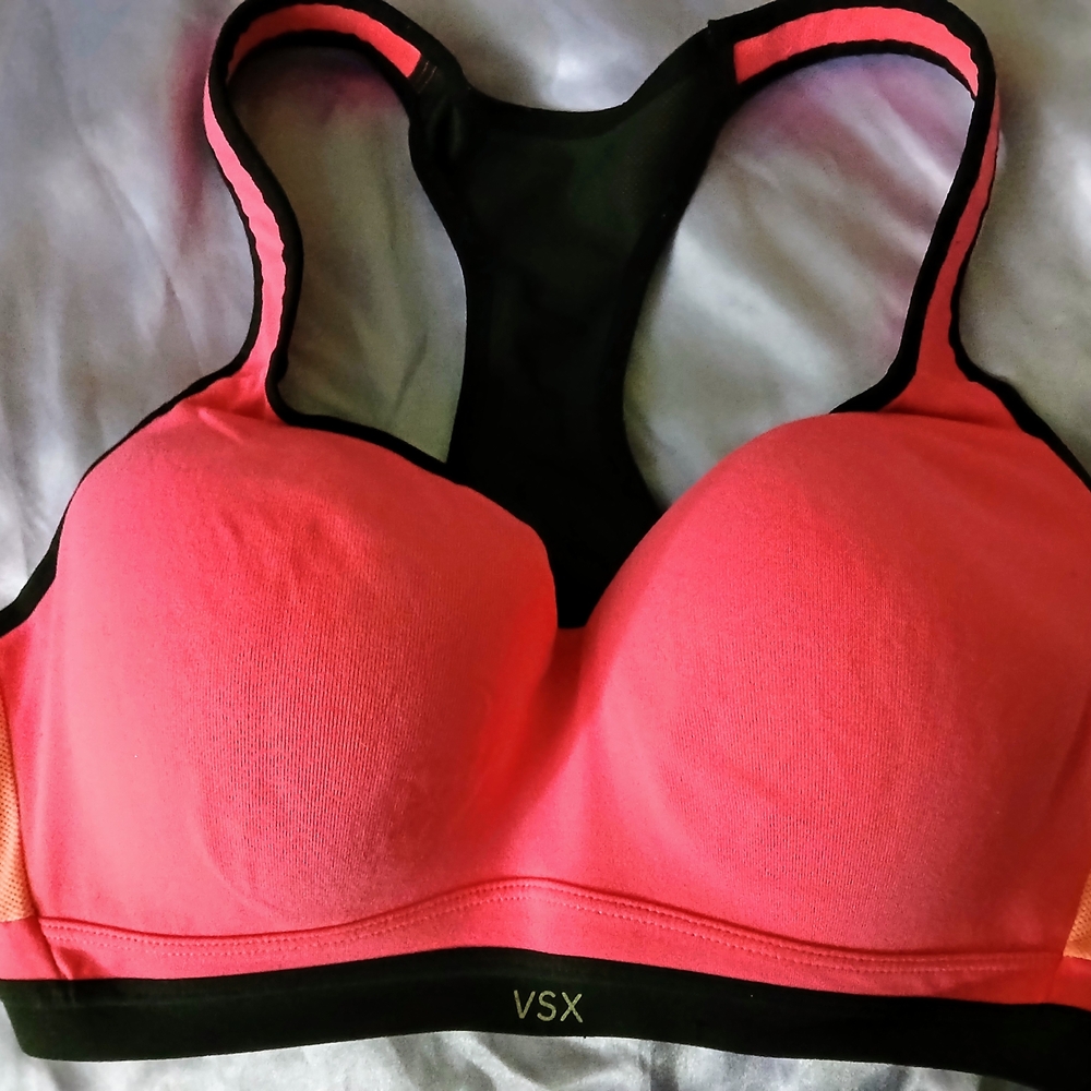 Vibrant Coral Sports Bra with Mesh Insert and Black Trim
